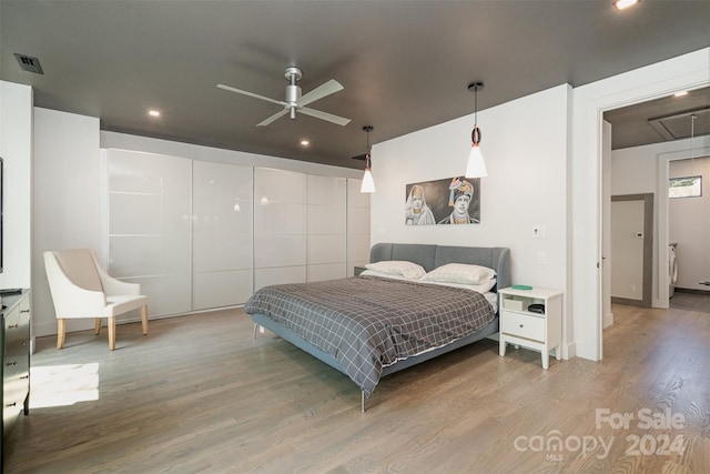 bedroom featuring ceiling fan and light hardwood / wood-style floors