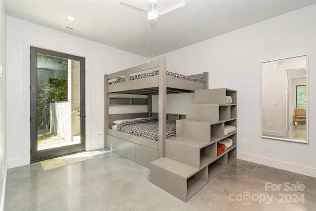 bedroom with access to exterior, ceiling fan, and concrete flooring