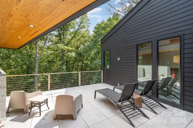 view of patio featuring a balcony and an outdoor living space