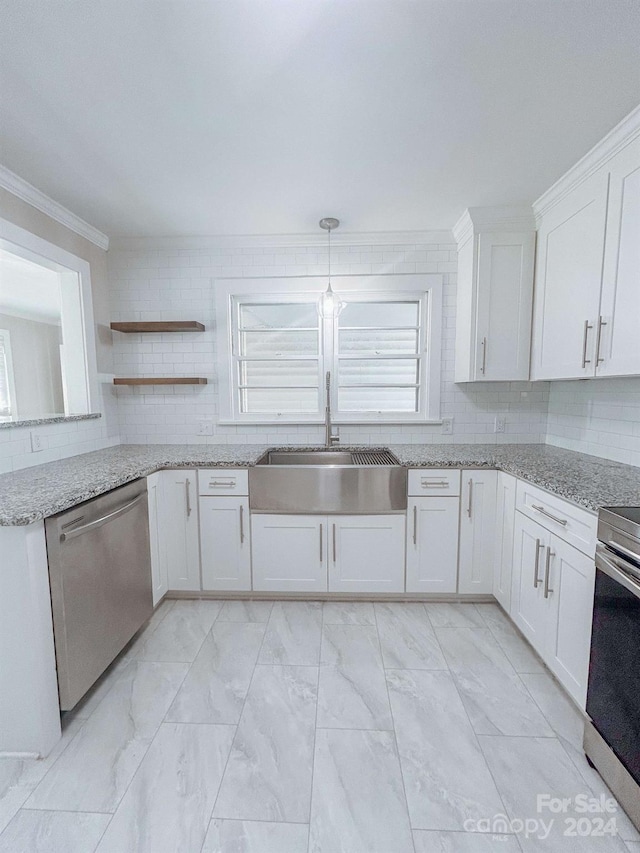 kitchen with ornamental molding, white cabinets, dishwasher, light tile patterned floors, and sink