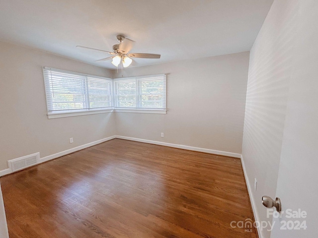 unfurnished room with plenty of natural light, ceiling fan, and wood-type flooring