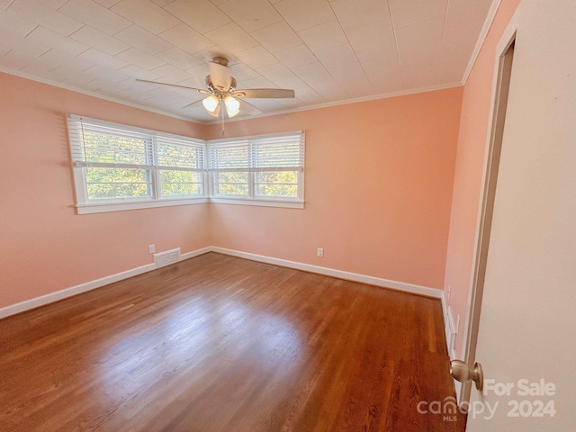 spare room with ceiling fan, crown molding, and wood-type flooring