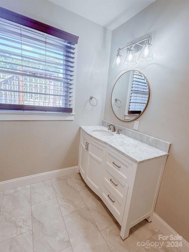 bathroom featuring tile patterned flooring and vanity