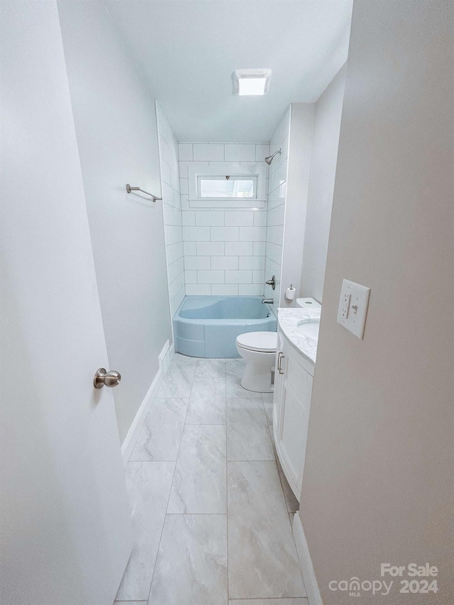 full bathroom featuring toilet, tiled shower / bath, vanity, and tile patterned floors