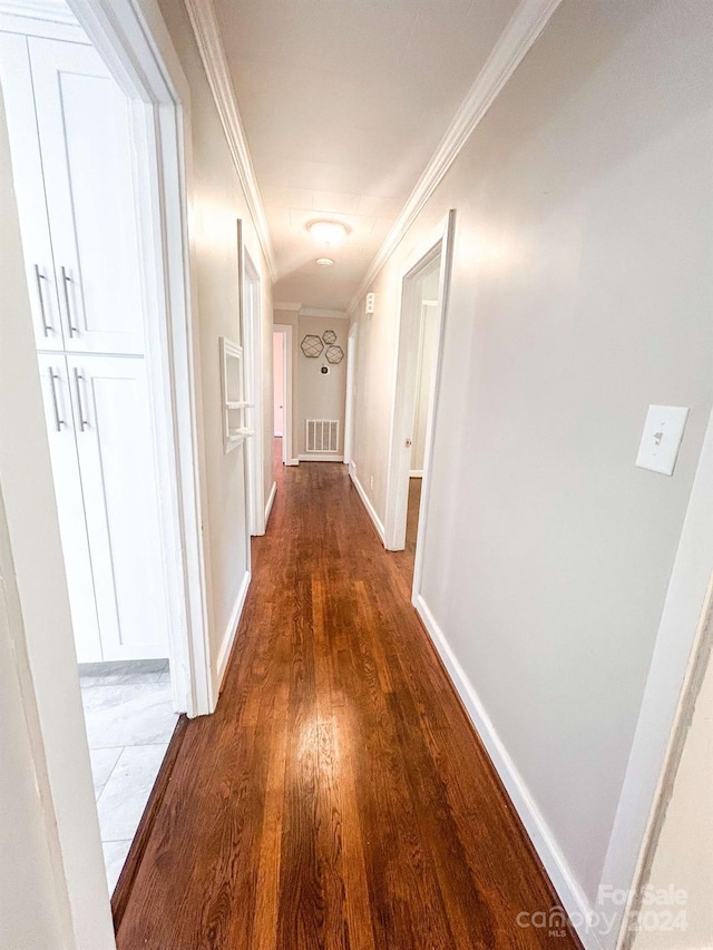 hallway with crown molding and wood-type flooring