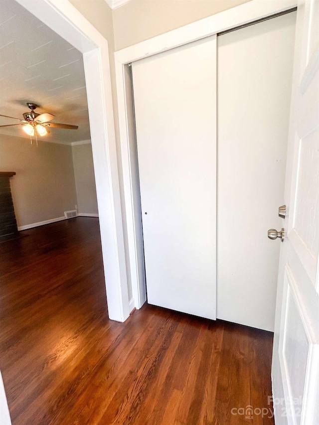 unfurnished bedroom featuring ceiling fan, crown molding, and hardwood / wood-style floors