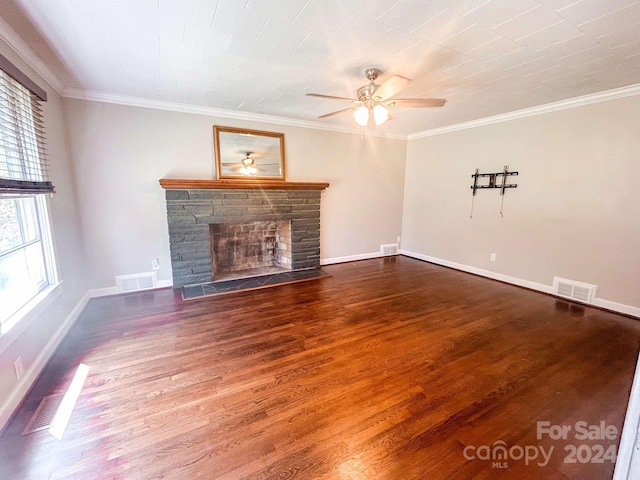 unfurnished living room with hardwood / wood-style flooring, crown molding, and a stone fireplace