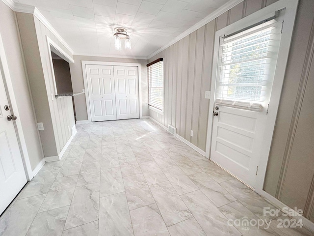 interior space featuring ornamental molding and light tile patterned floors