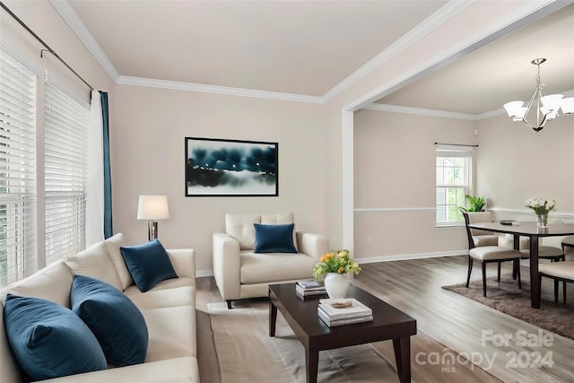 living room featuring a notable chandelier, crown molding, and hardwood / wood-style floors