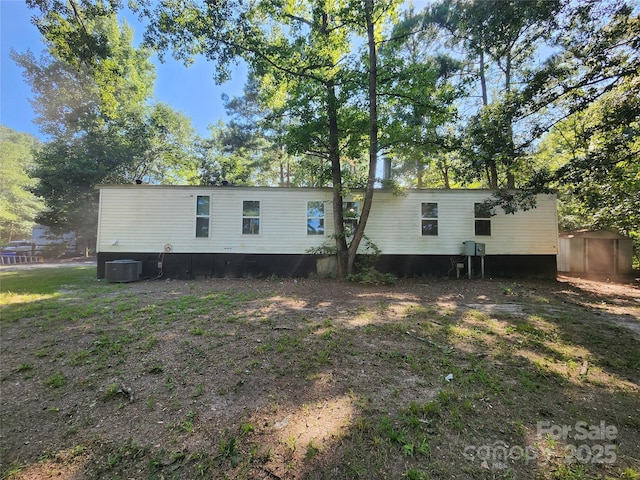 back of house with central AC