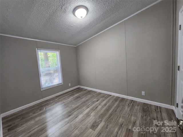 empty room featuring ornamental molding, hardwood / wood-style floors, and a textured ceiling