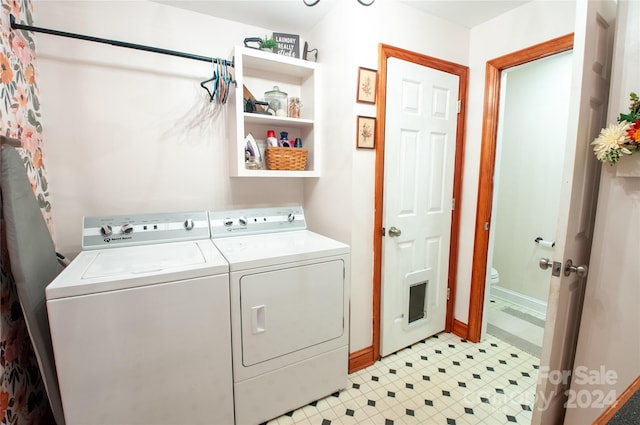 clothes washing area with washing machine and dryer