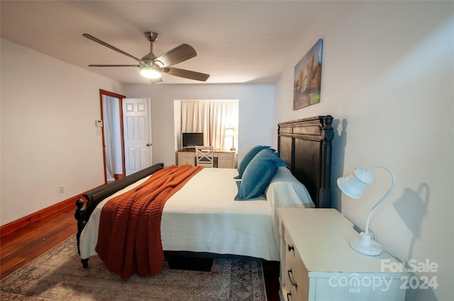 bedroom with ceiling fan and dark hardwood / wood-style floors