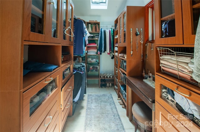 walk in closet with light tile patterned floors