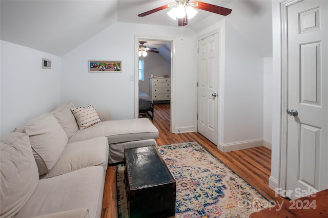 living room with lofted ceiling, ceiling fan, and light hardwood / wood-style floors