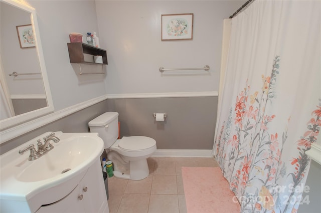 bathroom featuring tile patterned flooring, vanity, toilet, and a shower with shower curtain