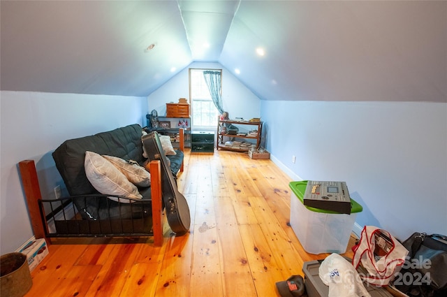 bedroom with lofted ceiling and hardwood / wood-style floors