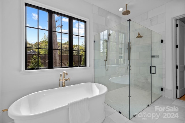 bathroom featuring tile patterned flooring and separate shower and tub