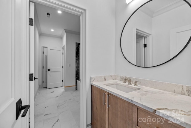 bathroom with tile patterned floors, vanity, and ornamental molding