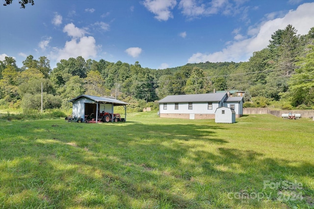 exterior space with a yard and a shed