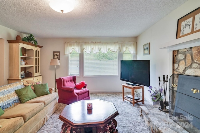 carpeted living room featuring a textured ceiling and a stone fireplace