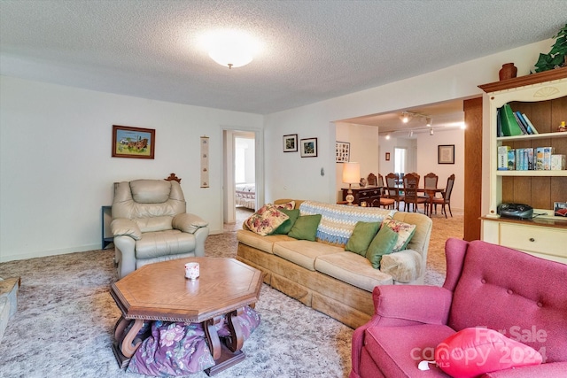 living room with a textured ceiling and carpet floors