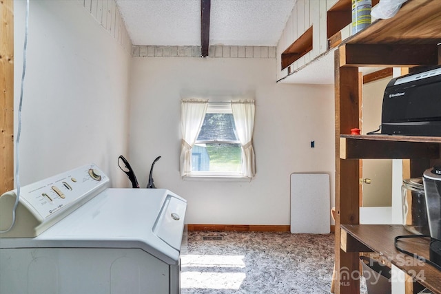 laundry area with a textured ceiling, washer / clothes dryer, and light colored carpet