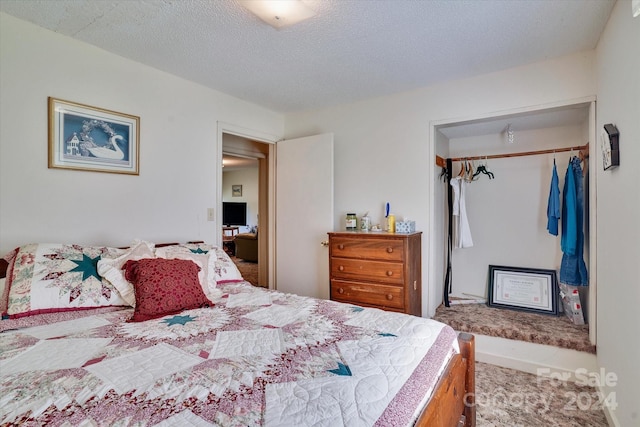 bedroom featuring a closet, a textured ceiling, and carpet flooring