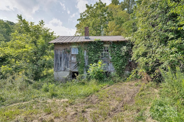 view of property exterior featuring an outbuilding