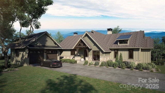 craftsman house featuring a garage, stone siding, driveway, board and batten siding, and a front yard