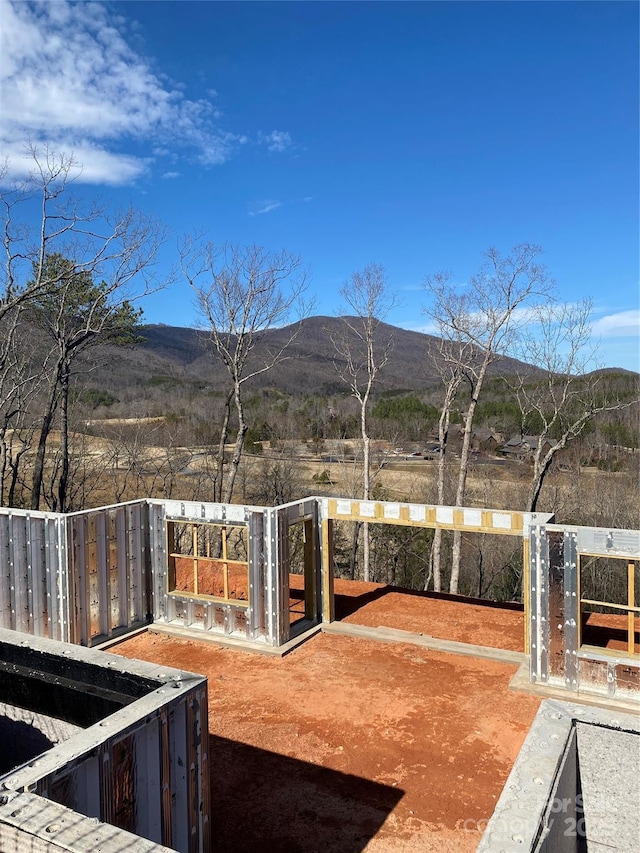 view of yard featuring fence and a mountain view