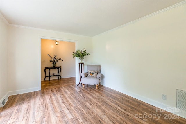 sitting room featuring crown molding and wood-type flooring