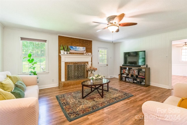 living room with ceiling fan, hardwood / wood-style floors, and plenty of natural light