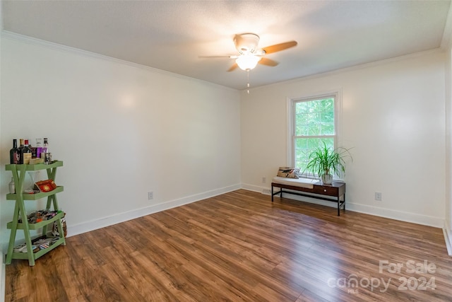 empty room featuring ceiling fan, hardwood / wood-style flooring, and ornamental molding