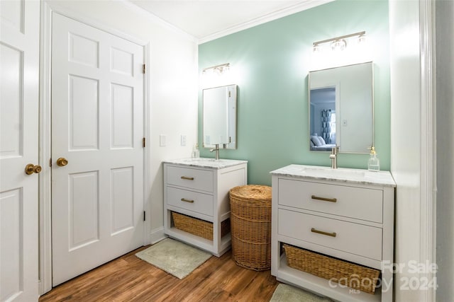 bathroom featuring crown molding, vanity, and hardwood / wood-style floors