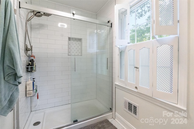 bathroom featuring a shower with shower door