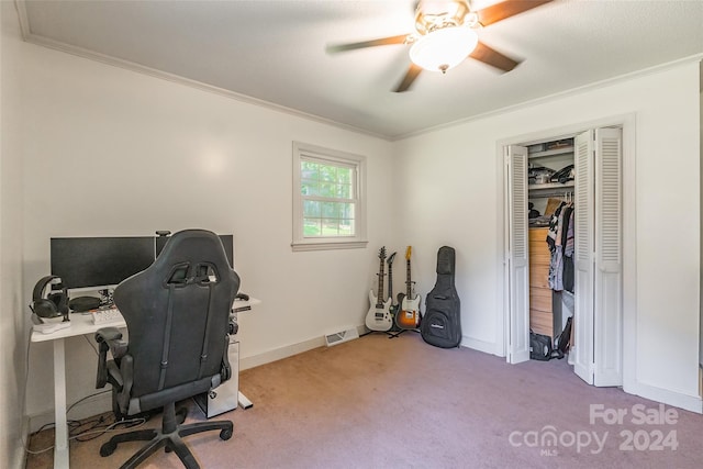 carpeted home office featuring ceiling fan and crown molding