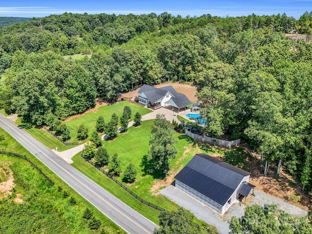 birds eye view of property with a wooded view