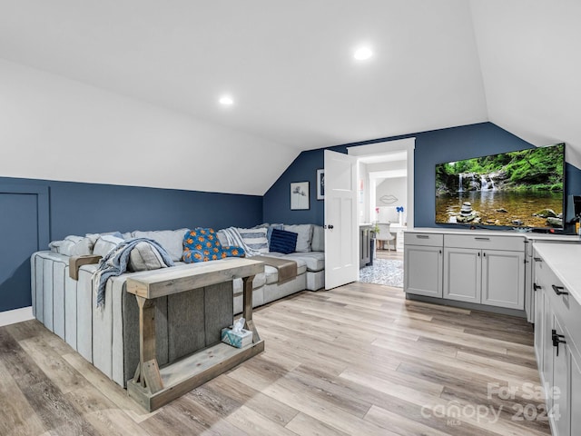 living room with lofted ceiling and light hardwood / wood-style flooring