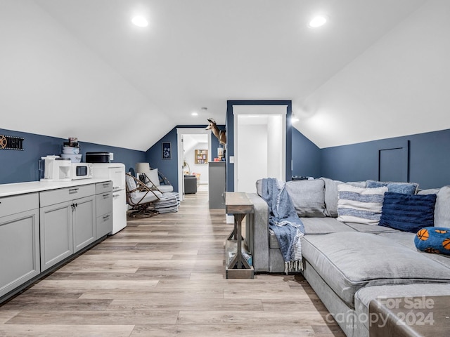 living room with light wood-type flooring and lofted ceiling