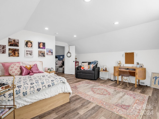 bedroom featuring dark wood-type flooring and vaulted ceiling