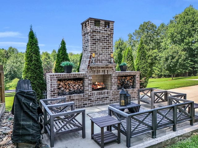 view of patio / terrace featuring an outdoor brick fireplace