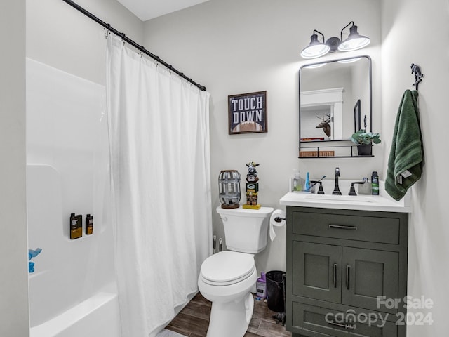 full bathroom with vanity, hardwood / wood-style flooring, toilet, and shower / bath combo with shower curtain