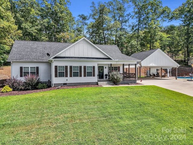 view of front of house with a carport, a porch, and a front lawn