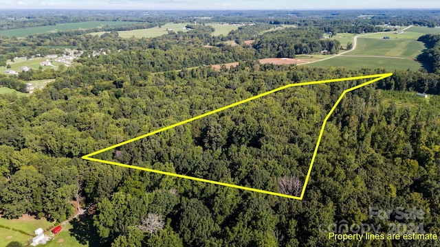 birds eye view of property featuring a view of trees