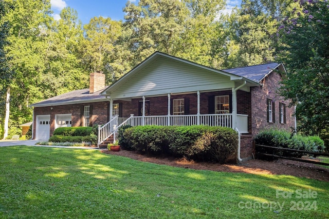 ranch-style home featuring a front lawn, a garage, and a porch