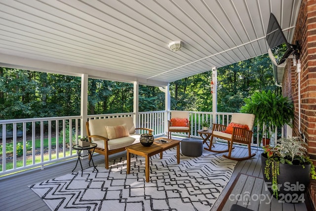 wooden terrace featuring an outdoor hangout area