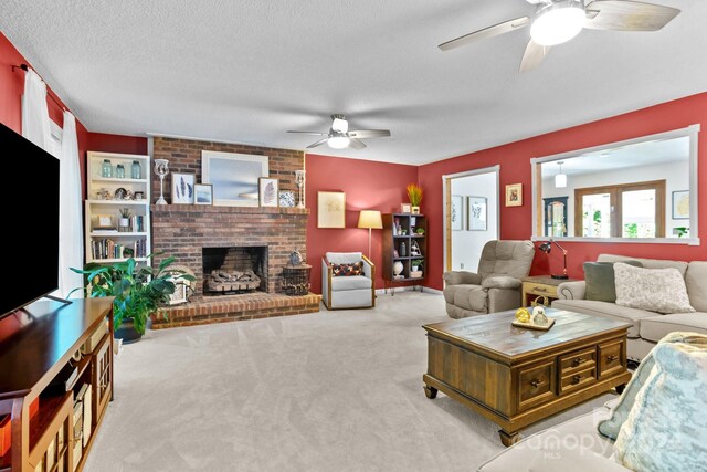 living room with ceiling fan, carpet flooring, a textured ceiling, and a fireplace