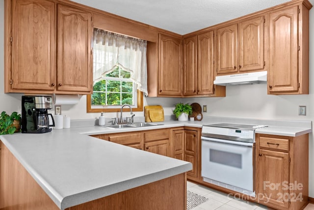 kitchen featuring sink, kitchen peninsula, stove, and light tile patterned floors