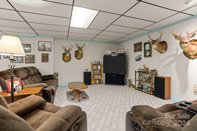 carpeted living room featuring a drop ceiling